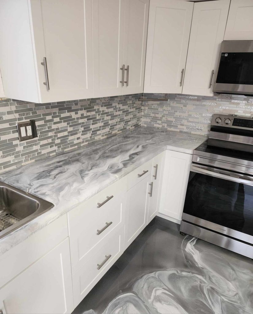 Gray and white epoxy paint swirled on a kitchen countertop and floor.